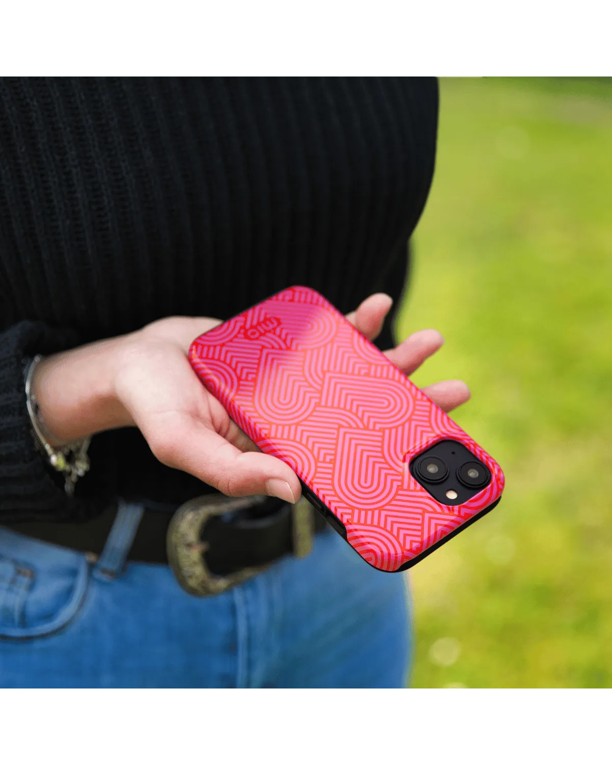 Hand houdt Samsung A55 5G met glanzend roze Mio hoesje met speels hartjesdesign vast.